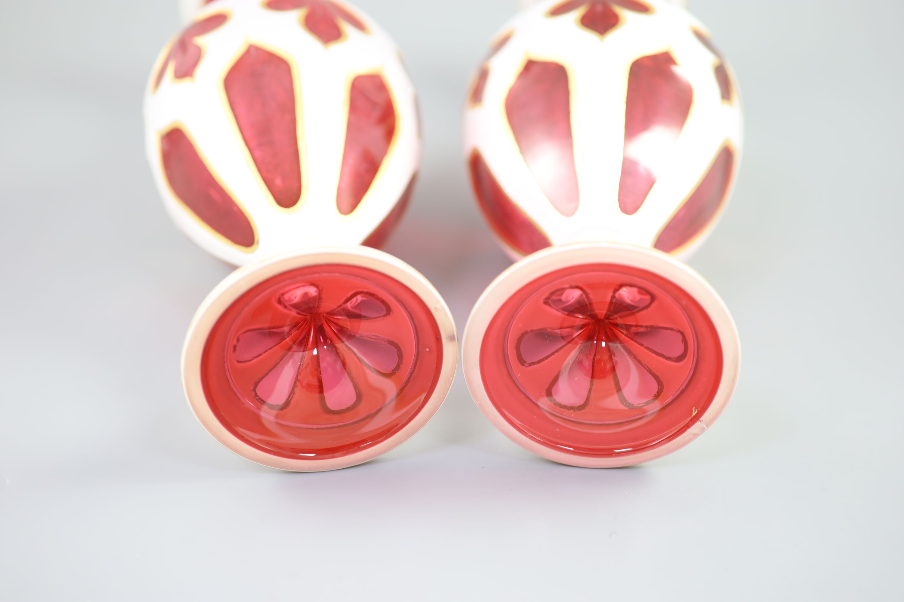 A pair of Bohemian white and ruby overlaid glass vases, 31cm high